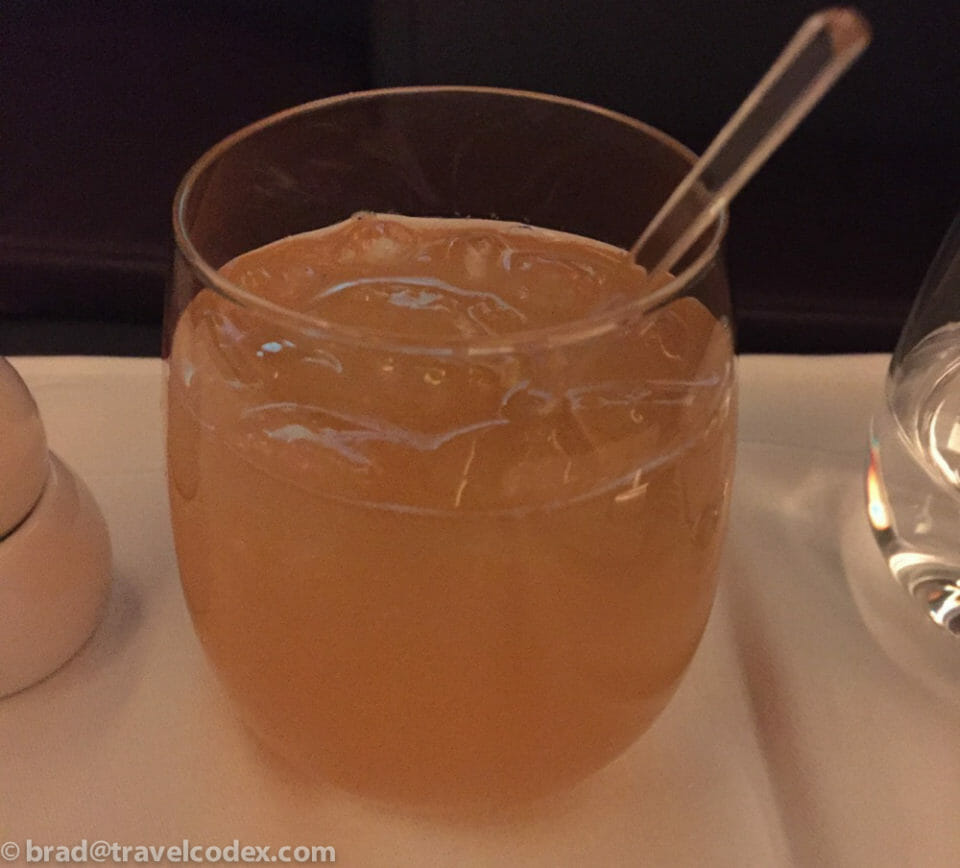a glass of liquid with a spoon