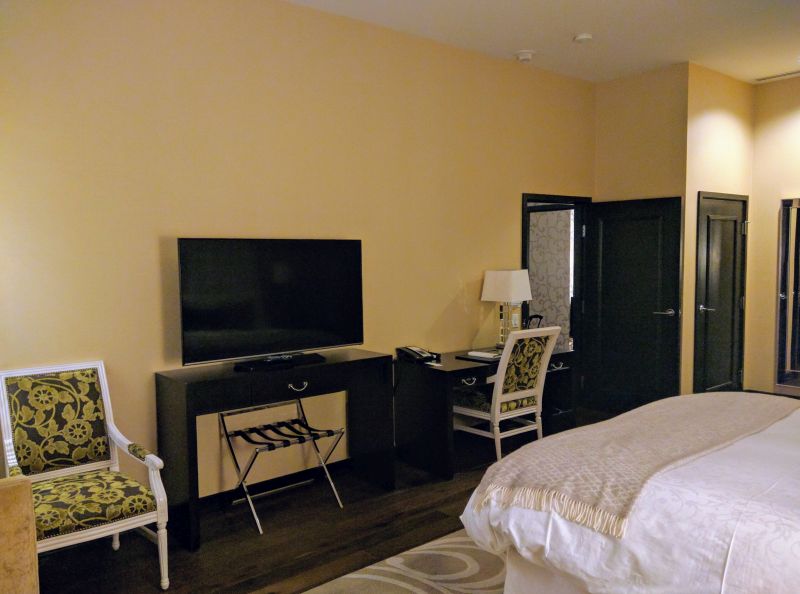 a room with a bed and a television