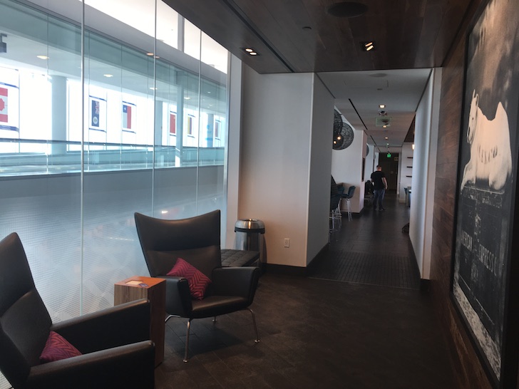 a hallway with chairs and a table