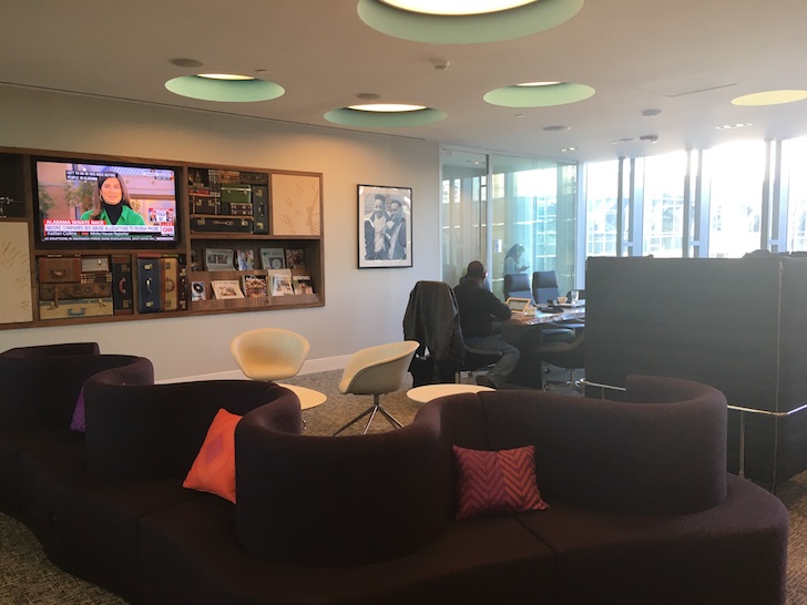 a room with a couch and a television on the wall