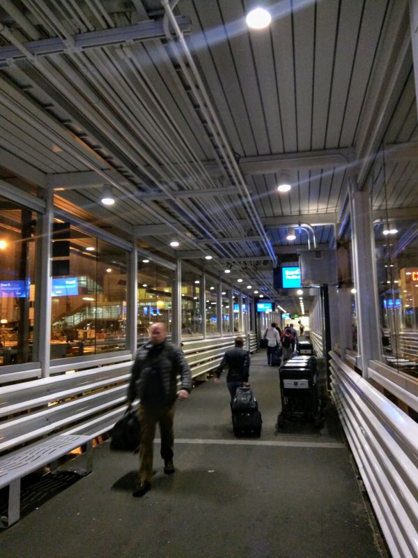 people walking in a building with luggage