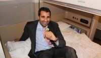 a man in a suit sitting on a bed
