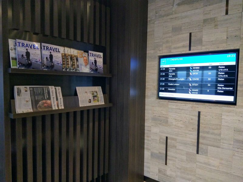 a tv and a shelf with magazines