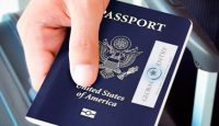 a hand holding a passport