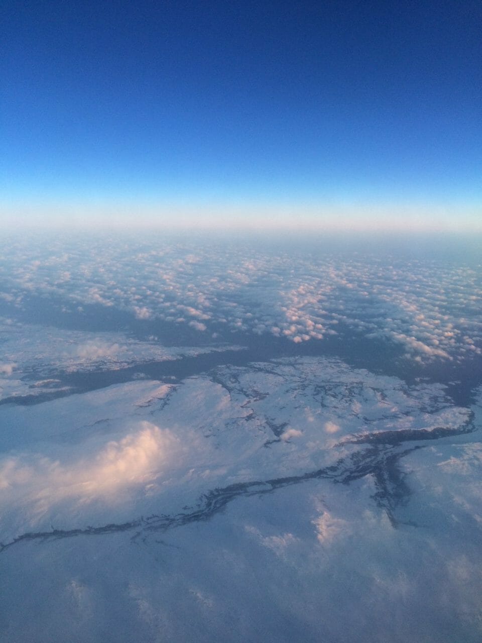 aerial view of clouds and land from an airplane