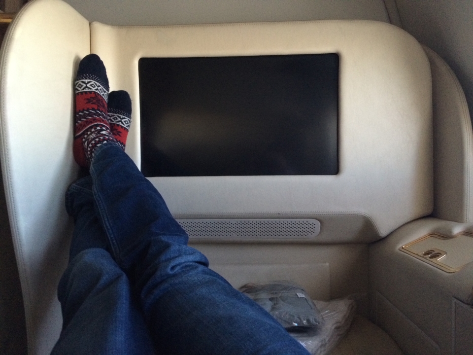 a person's legs in a chair with a tv
