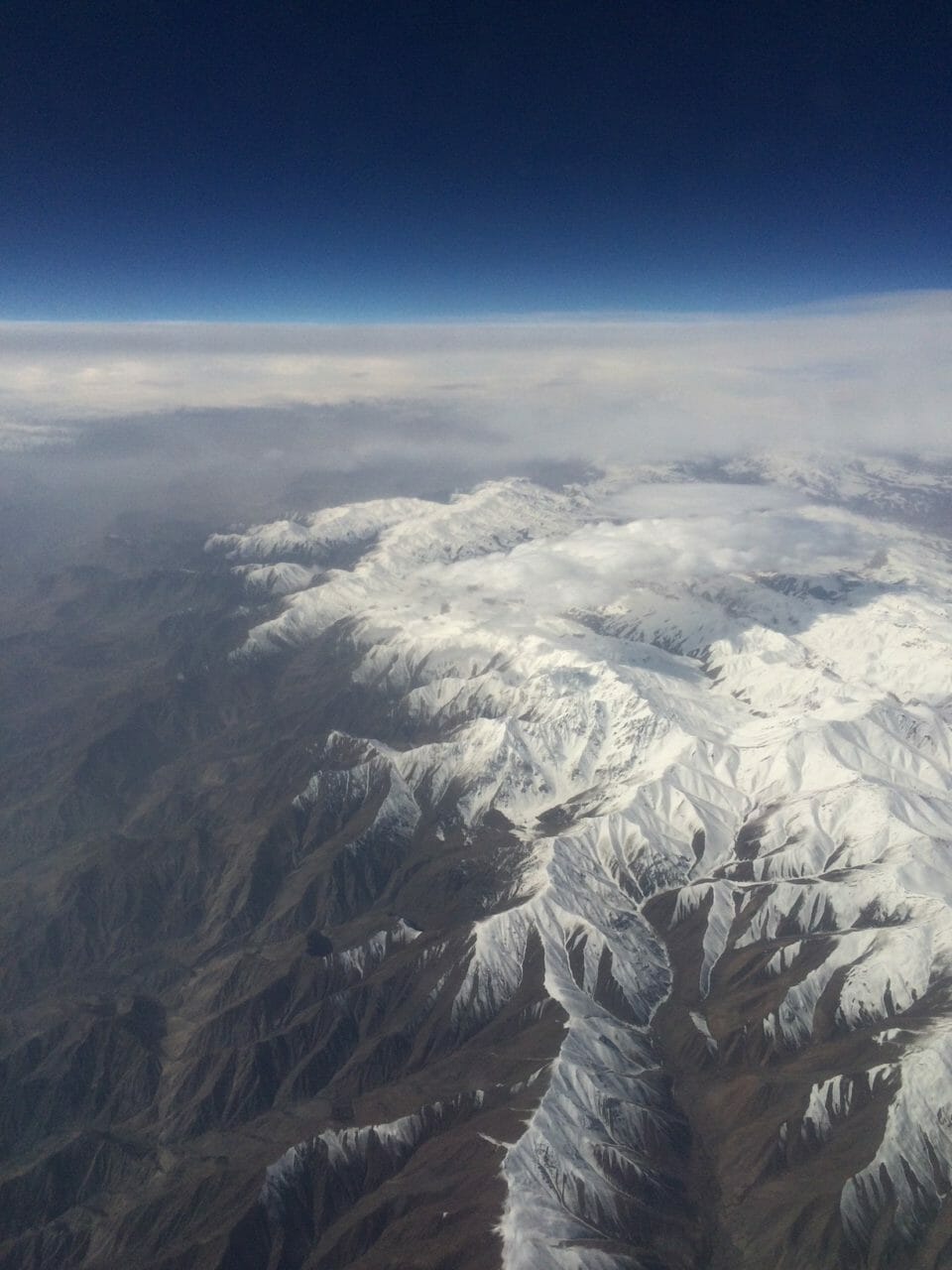 a aerial view of a snowy mountain range
