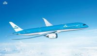 a blue and white airplane flying in the sky