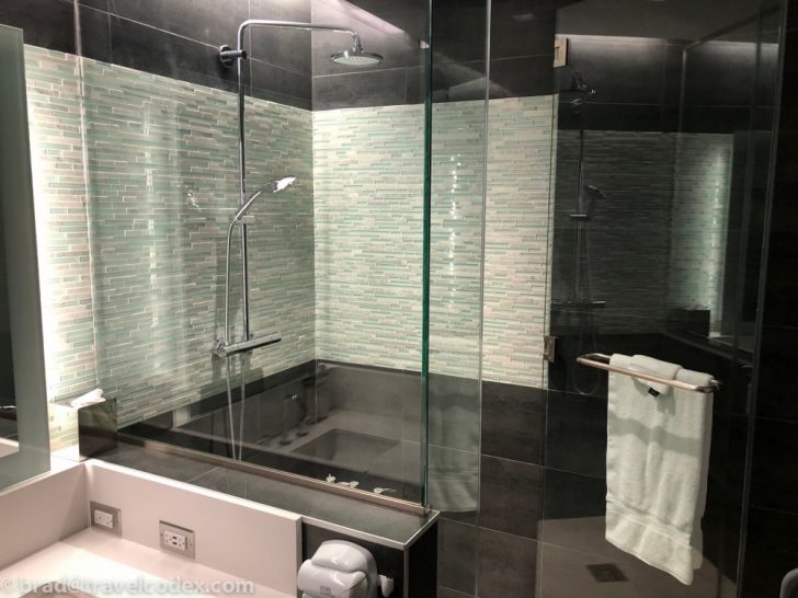 a bathroom with a glass shower and bathtub