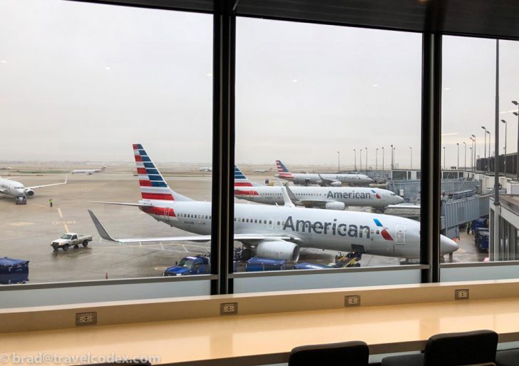 a group of airplanes parked at an airport