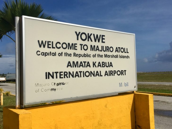 a sign on a yellow wall