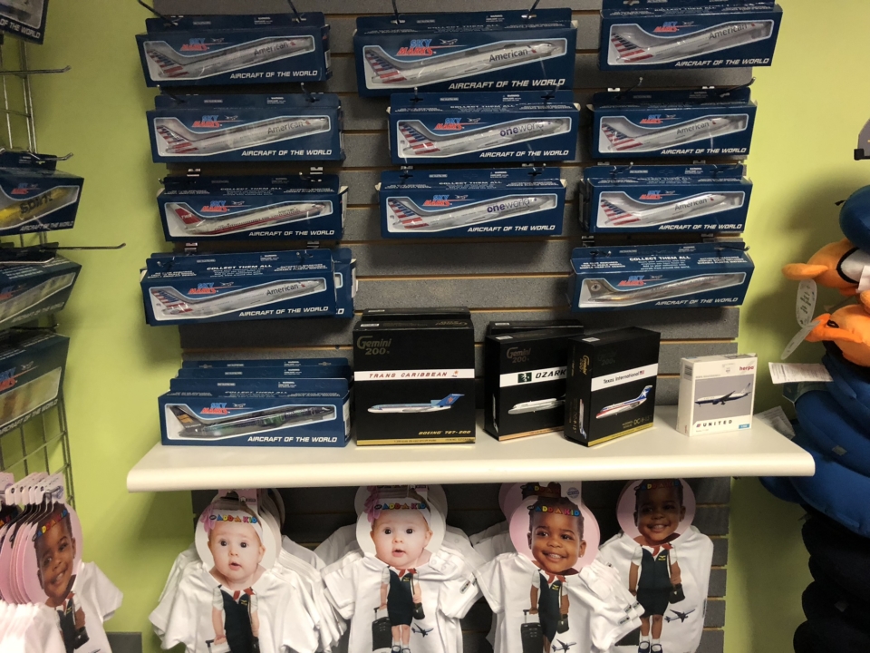 a shelf with model airplanes and toys
