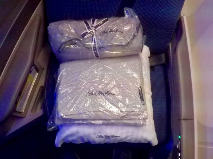 a stack of blankets and blankets in a seat