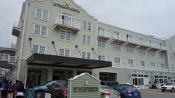 a building with a sign and cars parked in front of it
