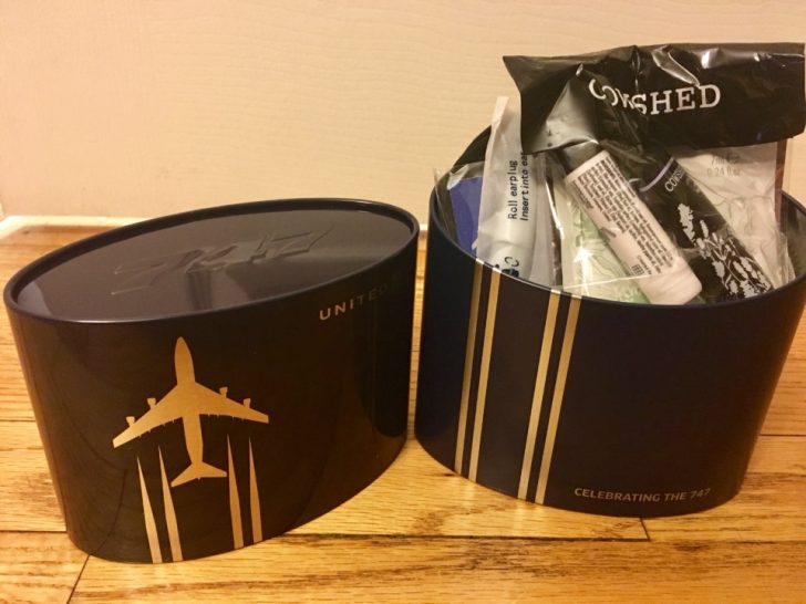 a black round container with a black lid and a white stripe on it