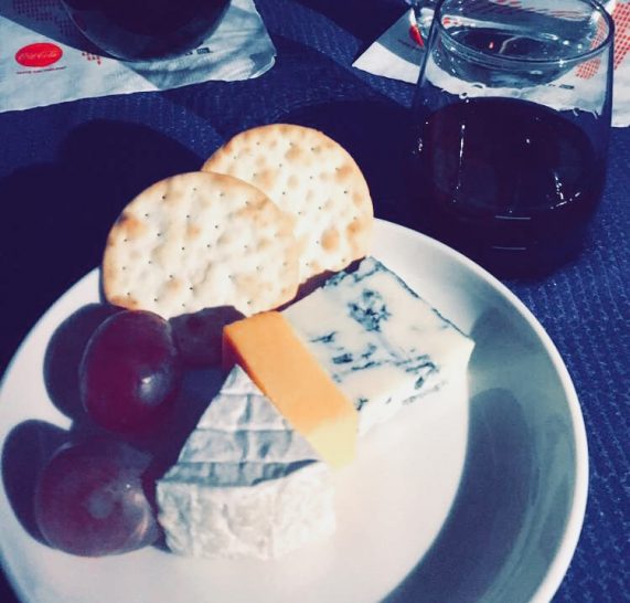 a plate of cheese and grapes