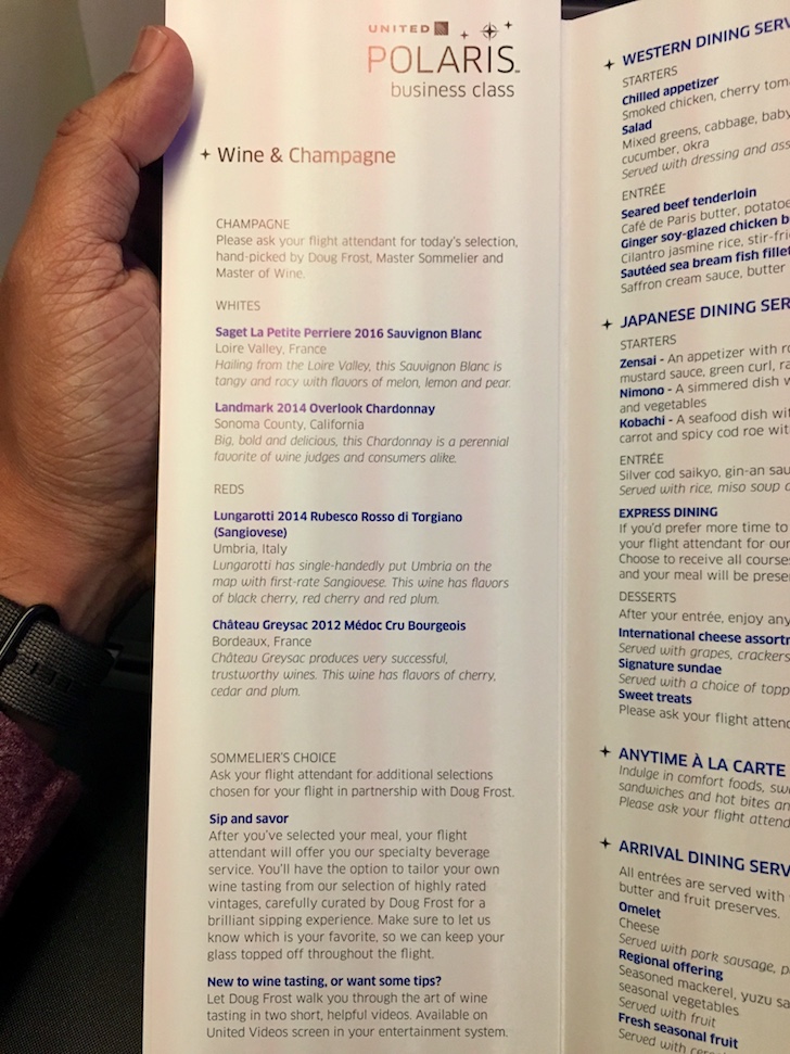a hand holding a menu