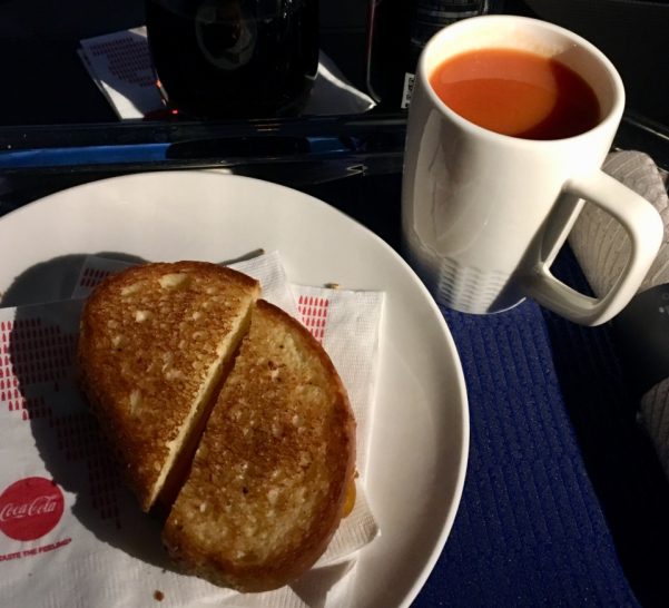 a plate of food and a cup of tomato juice