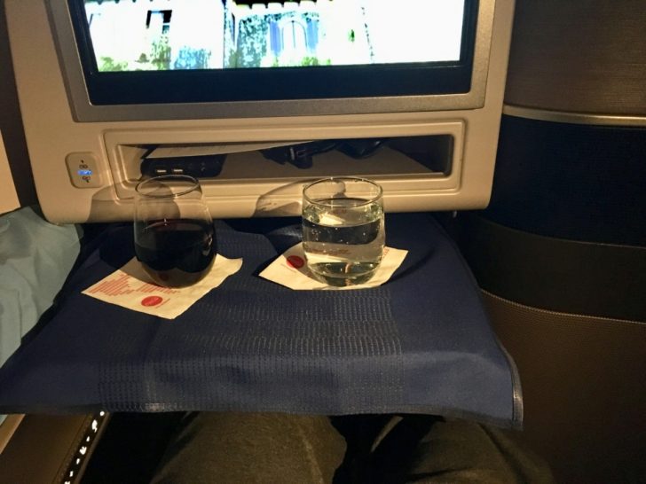 two glasses on a tray with a screen on the side