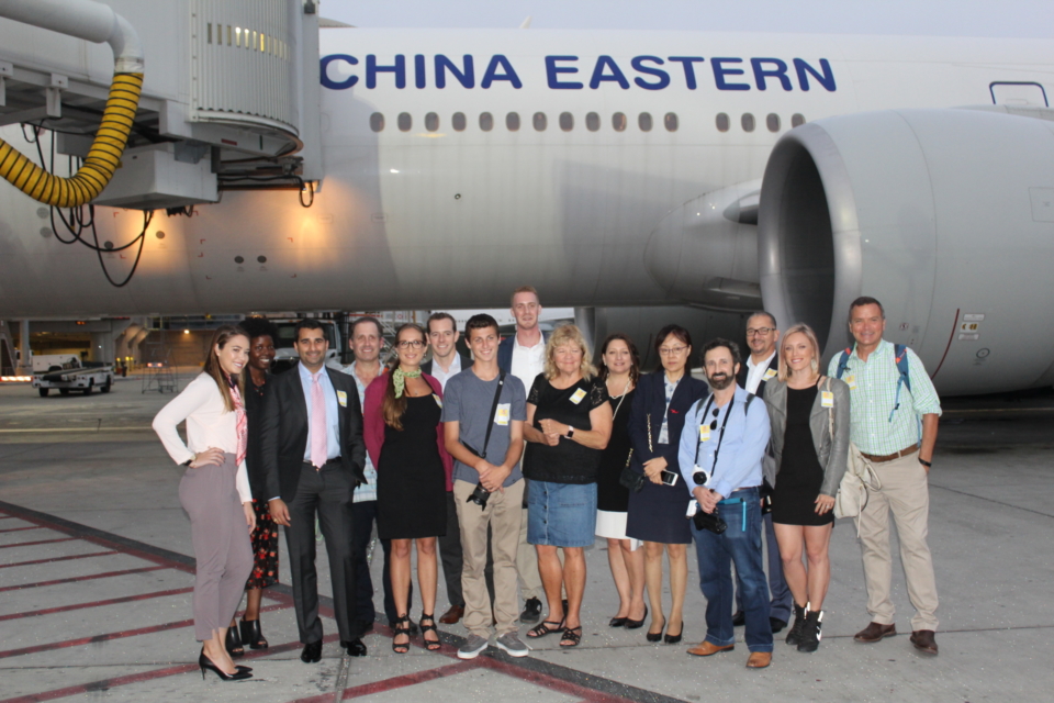 a group of people standing in front of an airplane