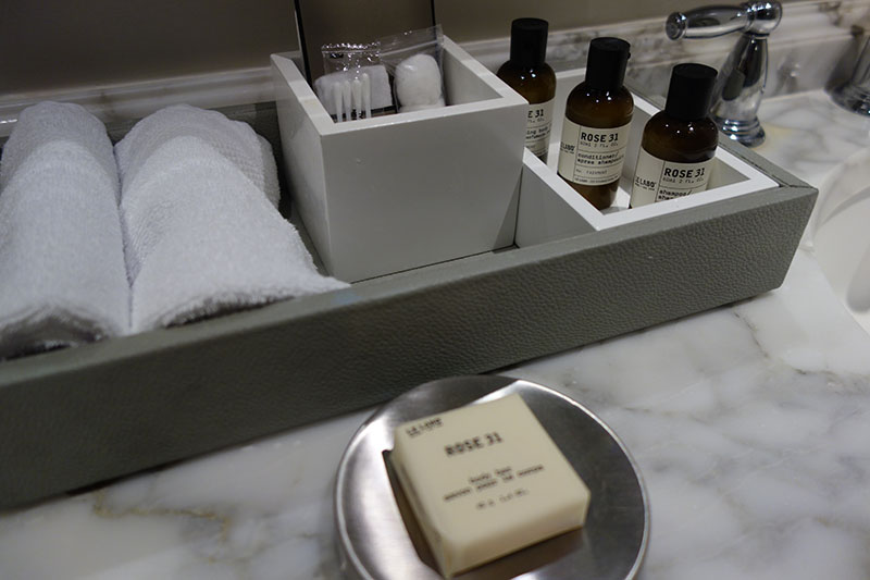 a bathroom counter with a soap and a towel