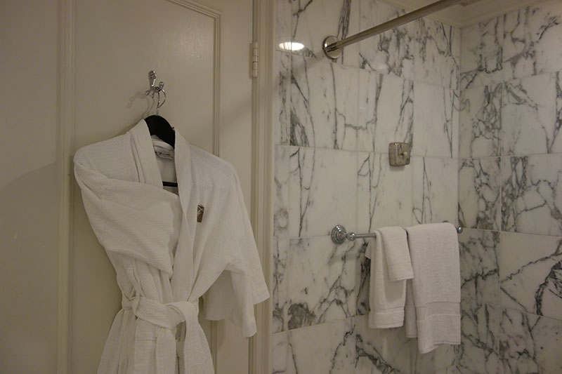 a white bathrobe on a hook