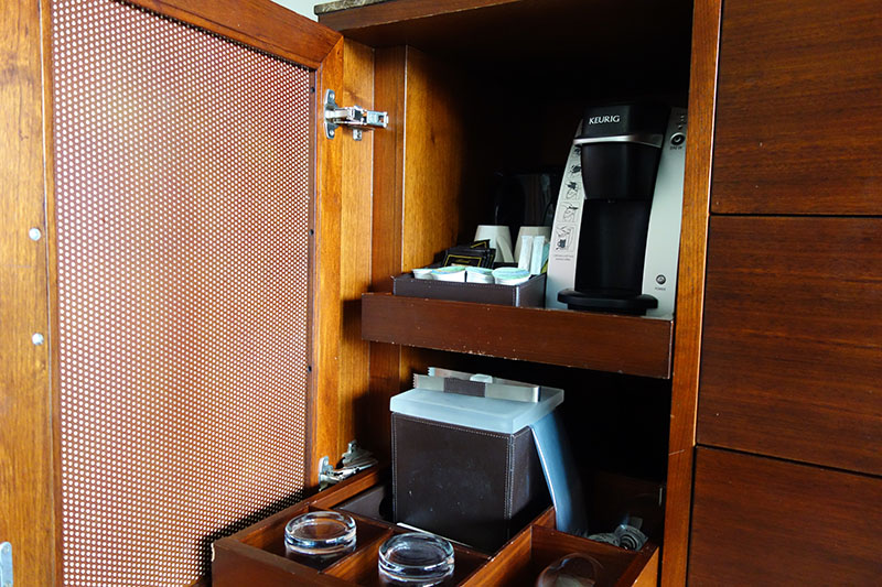 a coffee maker and other items in a cabinet