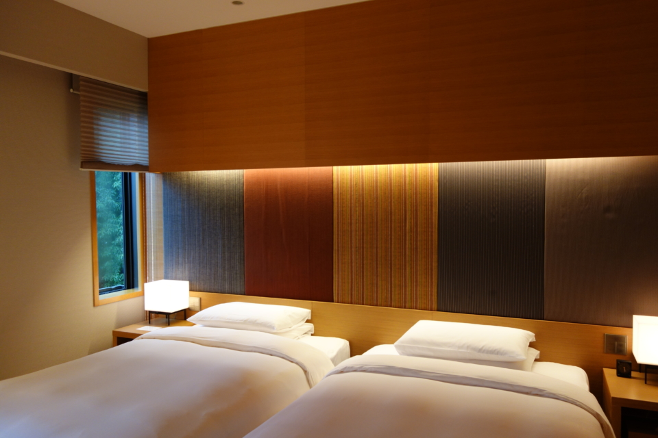 a room with two beds and a lamp