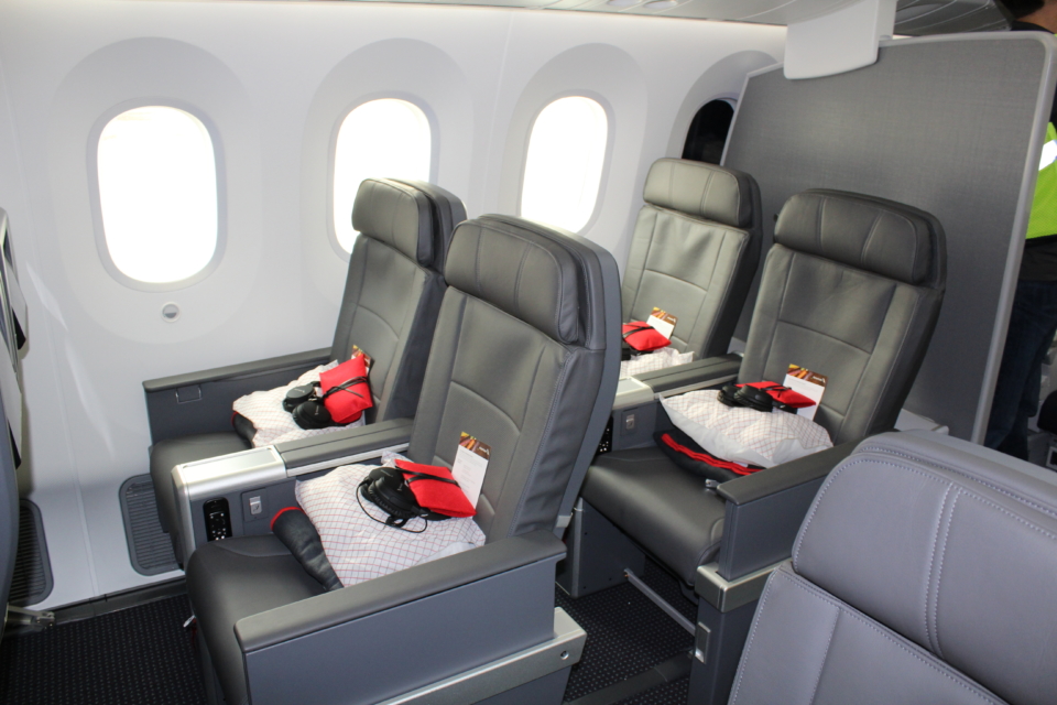 a row of grey chairs in an airplane