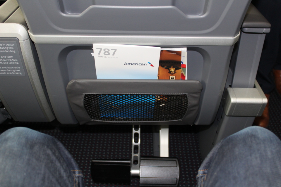 a paper in a pocket on a seat