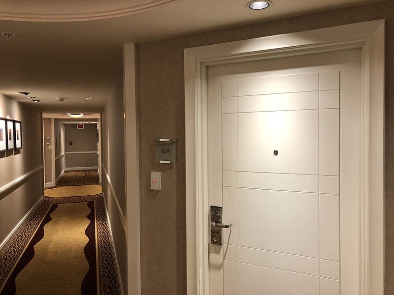 a hallway with a door and a light switch