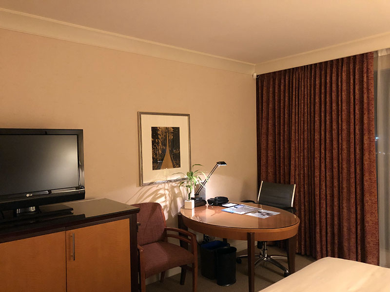 a room with a table and chairs and a tv