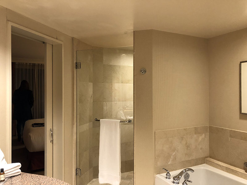 a bathroom with a bathtub and a towel rack