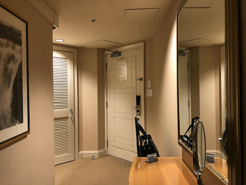 a room with a mirror and a desk