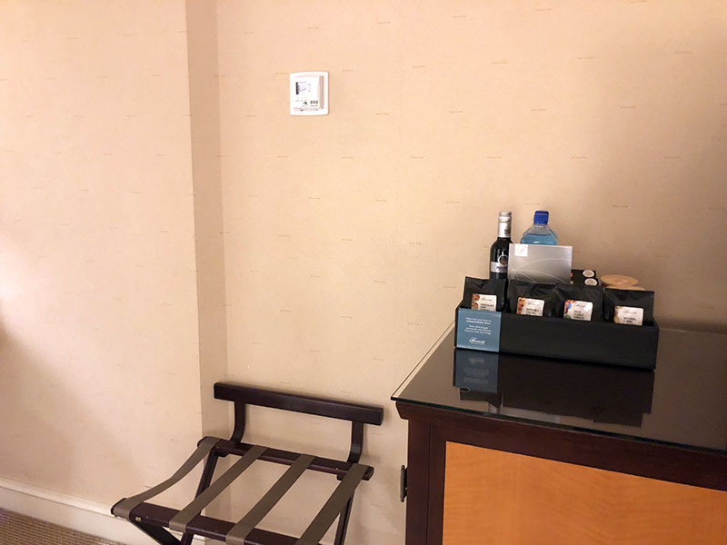 a table with a shelf of food and a chair in a room
