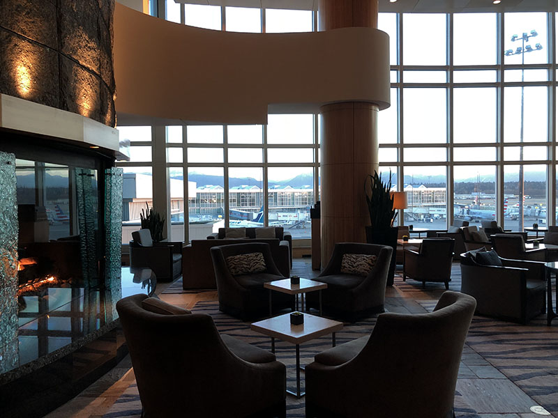 a room with a fireplace and chairs