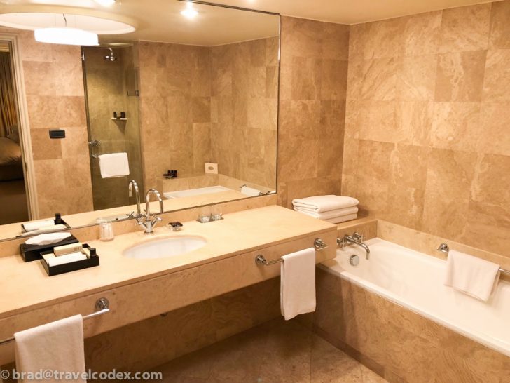 a bathroom with a large mirror and a bathtub