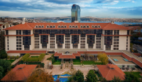 a large building with a pool and a large building in the background