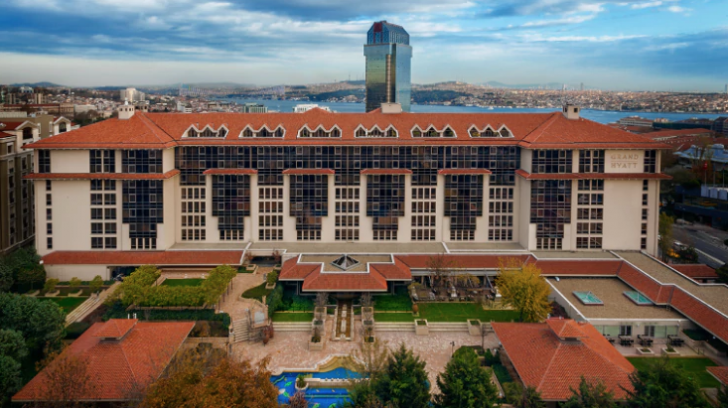 a large building with a pool and a large building in the background