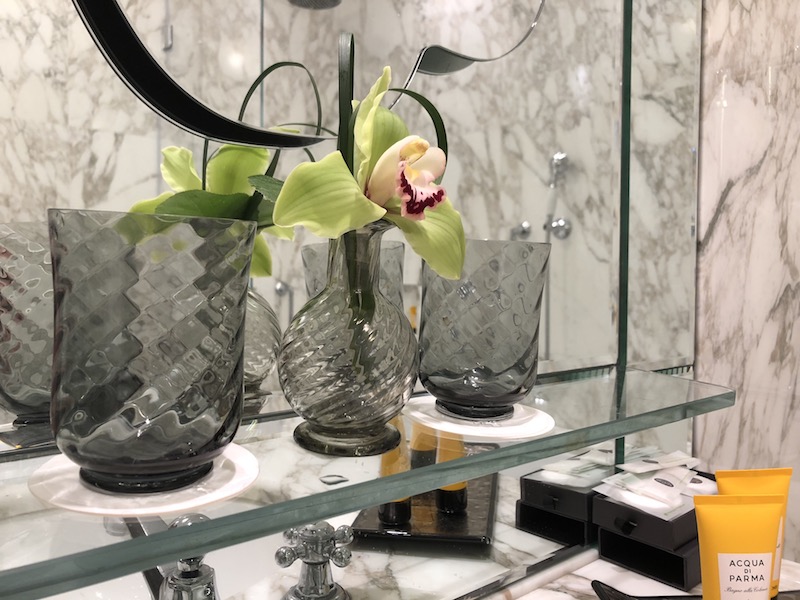 a vases with flowers on a shelf
