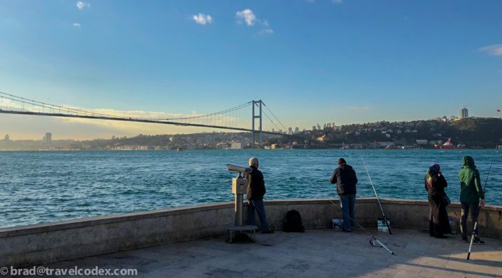 a group of people fishing on a pier