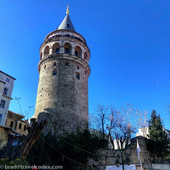a round stone tower with a pointed roof