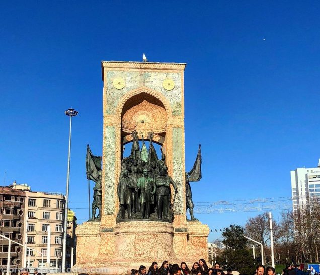 a group of people standing around a statue