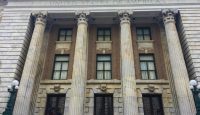 a building with columns and a sign