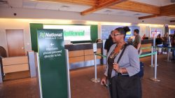 a woman standing in a check-in counter