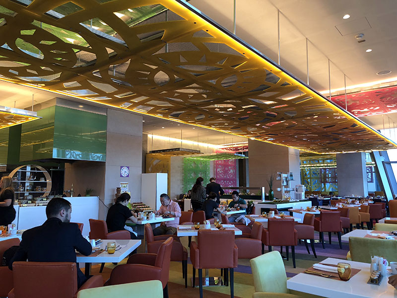 a group of people sitting at tables in a restaurant