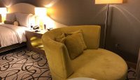 a bed and a chair in a hotel room