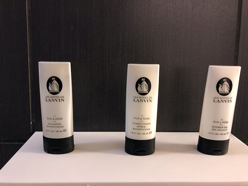 a group of white bottles with black text on them
