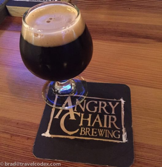 a glass of beer on a coaster
