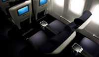 a seat and arm rest in an airplane